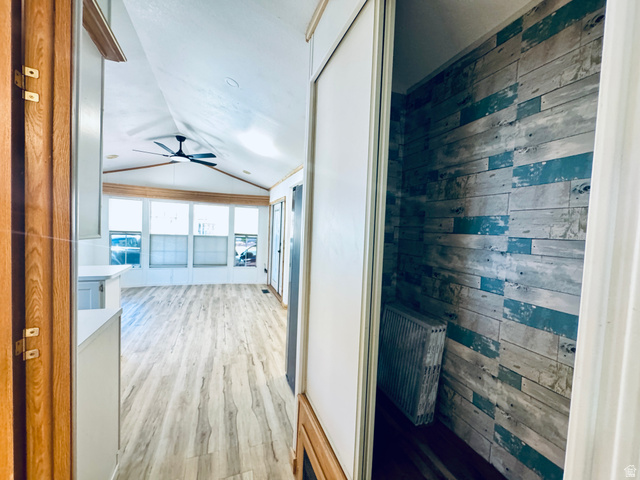 150 North 3050 East, Unit 4 St. George, UT 84790 - Photo 10 of 24 Open-concept living space featuring wood-finish flooring, a vaulted ceiling, and a contemporary ceiling fan