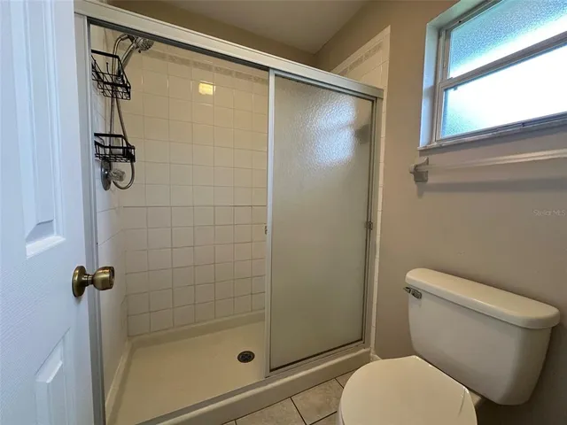 a bathroom with a toilet and a shower