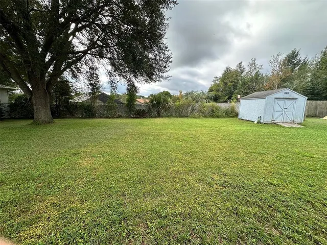 a view of a field with an trees