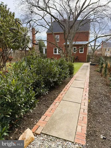 a view of a brick house with many windows