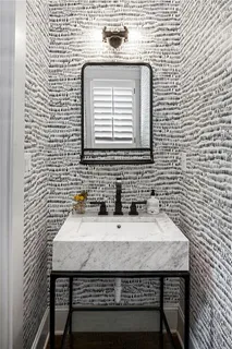 a bathroom with a sink a mirror and a window