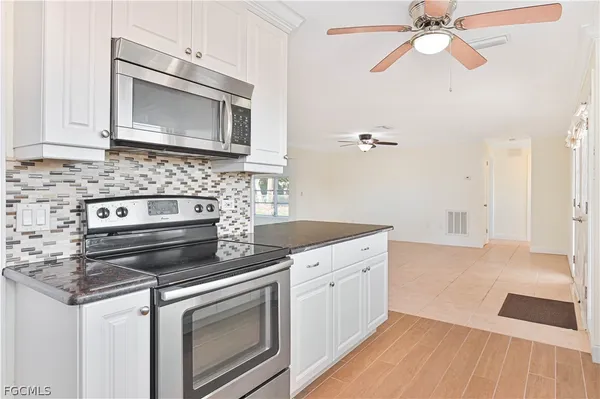 a kitchen with a stove and a microwave