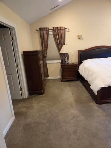 a bedroom with a bed and a walk in closet