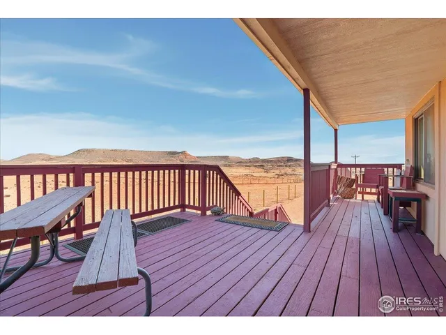 a view of balcony with wooden floor and city view