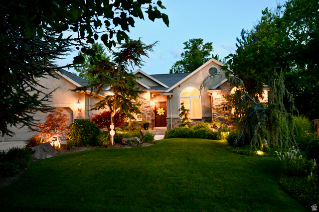 314 Brown Farm Lane Draper, UT 84020 - Photo 45 of 57 Stucco and stone facade with an arched window, a two-car garage, and meticulously maintained landscaping