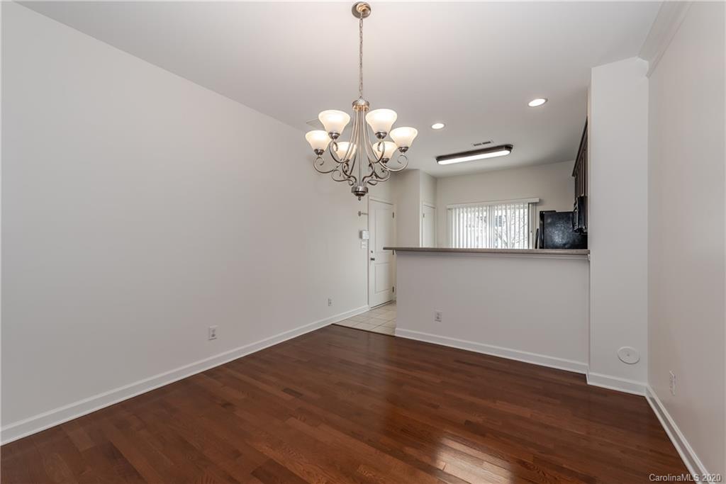8337 Scotney Bluff Avenue Charlotte, NC 28273 - Photo 12 of 31 a view of a room with wooden floor and chandelier