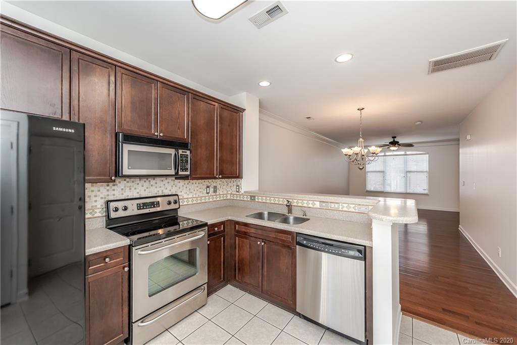 8337 Scotney Bluff Avenue Charlotte, NC 28273 - Photo 16 of 31 a kitchen with a sink stove and microwave