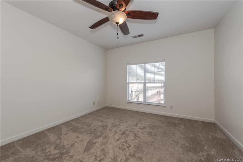 8337 Scotney Bluff Avenue Charlotte, NC 28273 - Photo 20 of 31 an empty room with a window and a fan