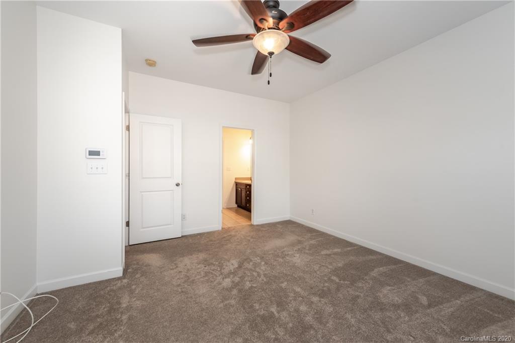 8337 Scotney Bluff Avenue Charlotte, NC 28273 - Photo 22 of 31 an empty room with closet and a chandelier fan