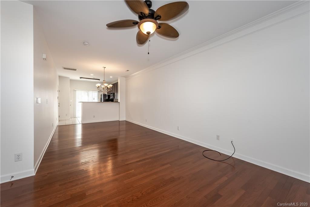8337 Scotney Bluff Avenue Charlotte, NC 28273 - Photo 6 of 31 a view of a kitchen with wooden floor a ceiling fan and windows