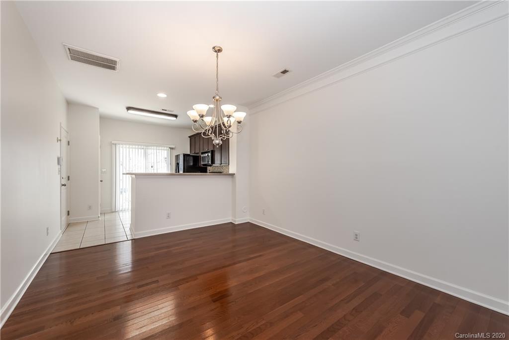 8337 Scotney Bluff Avenue Charlotte, NC 28273 - Photo 10 of 31 a view of a kitchen with a dishwasher and wooden floor