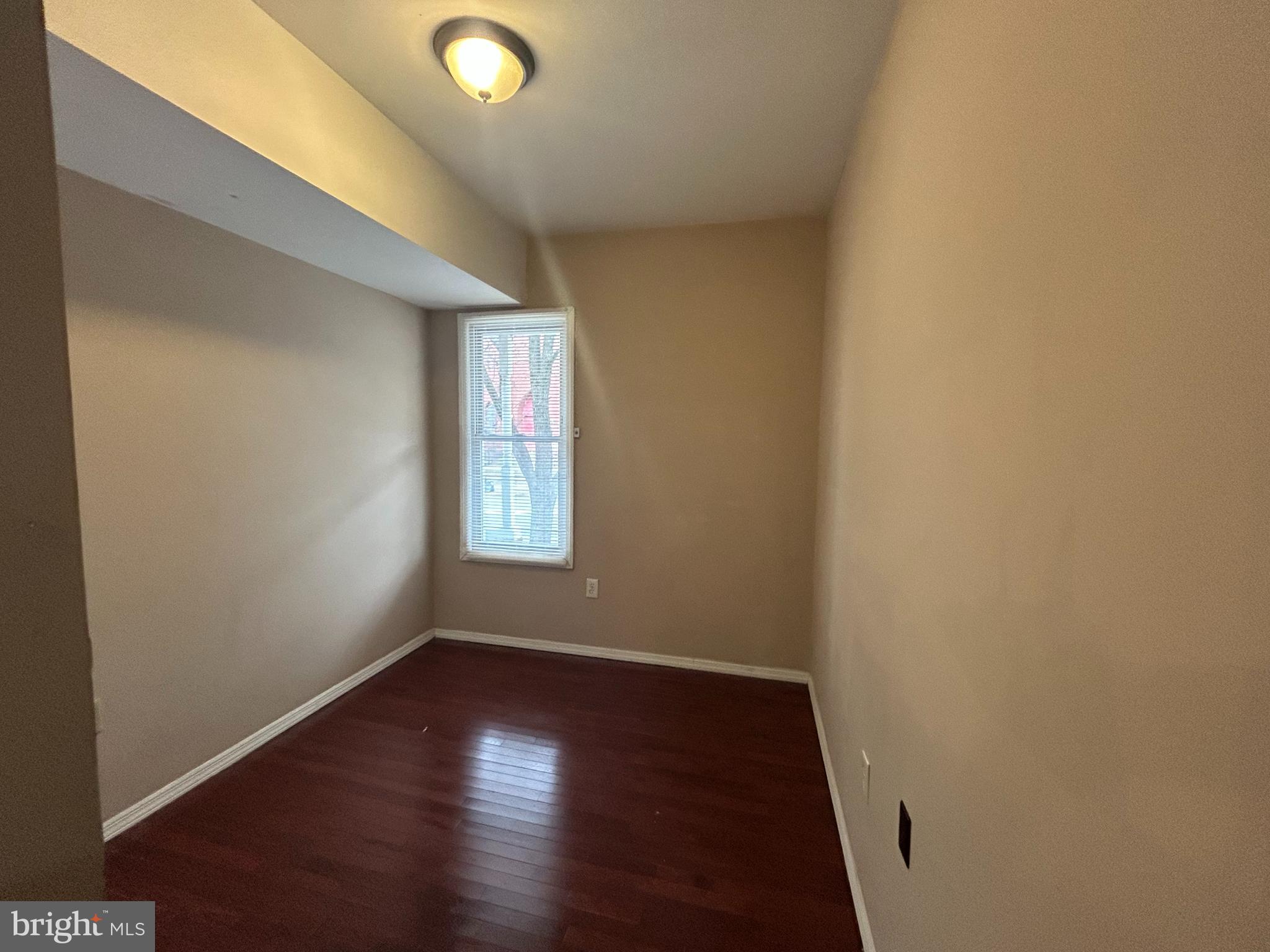 47-49 Hanover Street, Unit 49A Pemberton, NJ 08068 - Photo 11 of 12 an empty room with wooden floor and windows