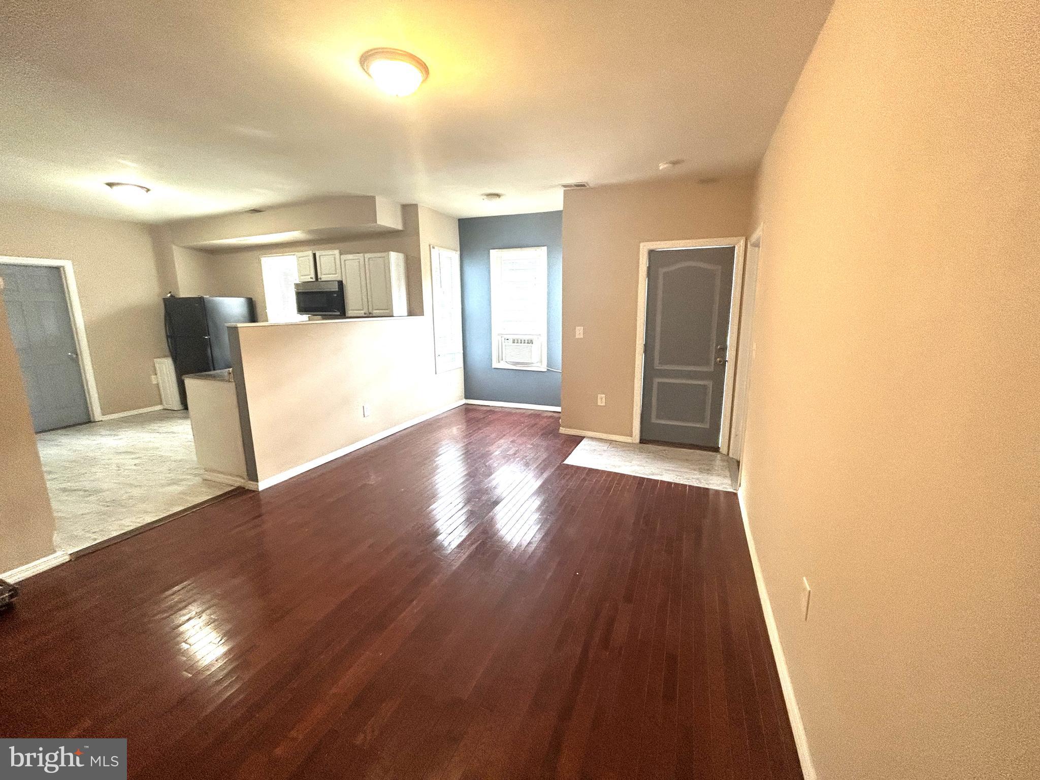 47-49 Hanover Street, Unit 49A Pemberton, NJ 08068 - Photo 3 of 12 a view of a big room with wooden floor and a kitchen