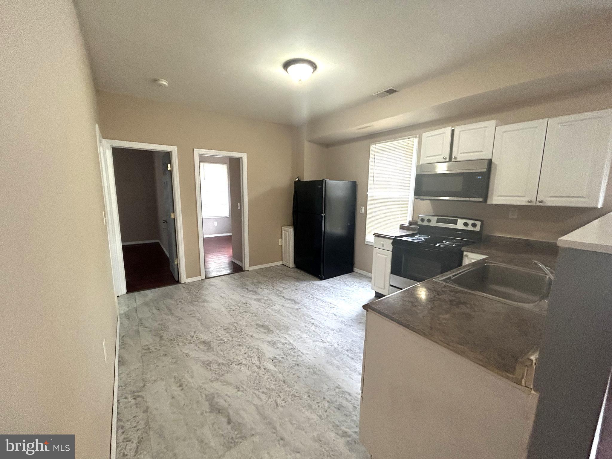 47-49 Hanover Street, Unit 49A Pemberton, NJ 08068 - Photo 5 of 12 a kitchen with refrigerator and window