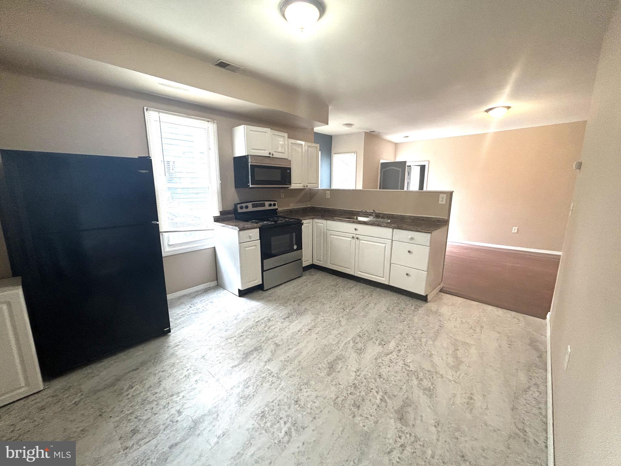 47-49 Hanover Street, Unit 49A Pemberton, NJ 08068 - Photo 6 of 12 a large kitchen with granite countertop a stove a sink dishwasher and a refrigerator