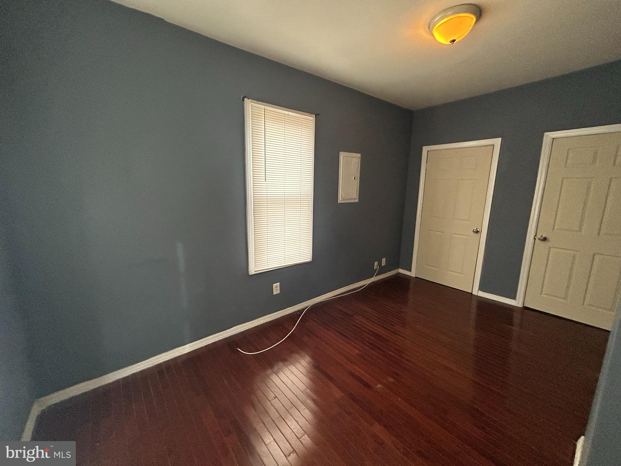 47-49 Hanover Street, Unit 49A Pemberton, NJ 08068 - Photo 8 of 12 an empty room with wooden floor and windows