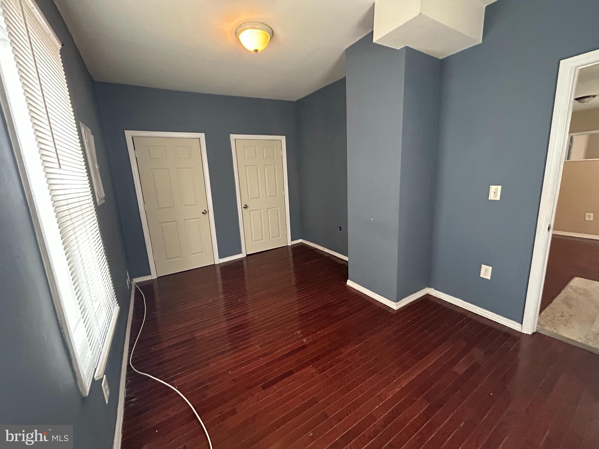 47-49 Hanover Street, Unit 49A Pemberton, NJ 08068 - Photo 9 of 12 an empty room with wooden floor and windows