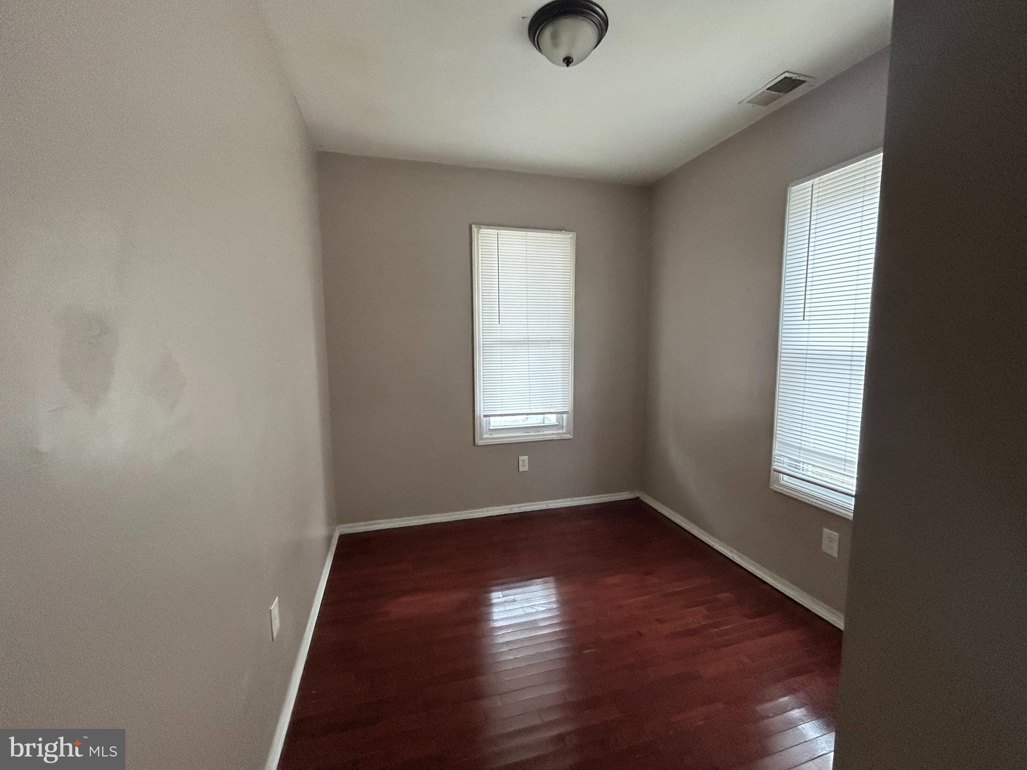 47-49 Hanover Street, Unit 49A Pemberton, NJ 08068 - Photo 10 of 12 an empty room with wooden floor and windows