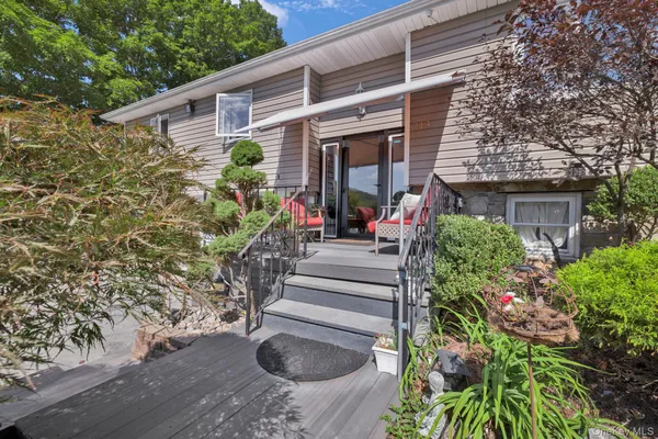 a view of a house with potted plants