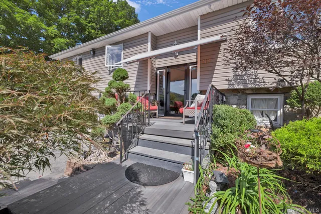 a view of a house with potted plants
