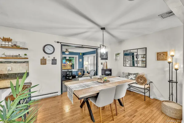 a view of a dining room with furniture window and wooden floor