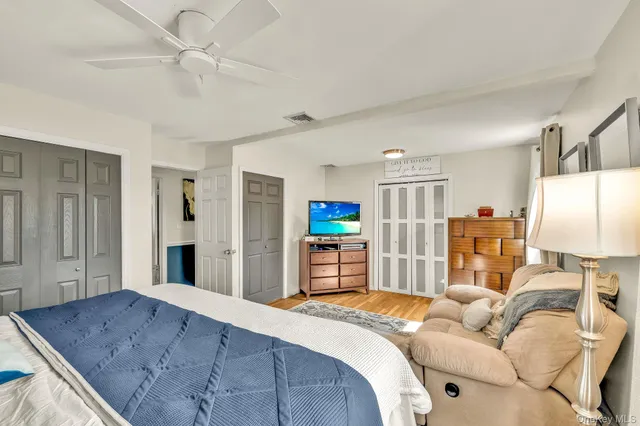 a bedroom with furniture and wooden floor