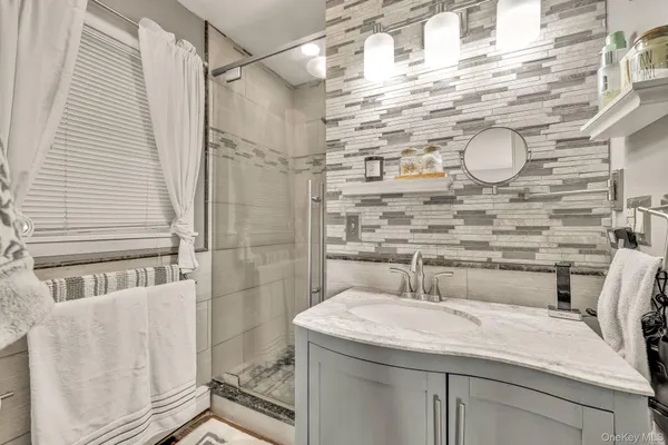 a bedroom with a bed couch and a window