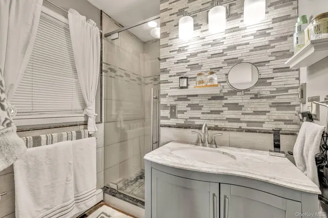 a bedroom with a bed couch and a window