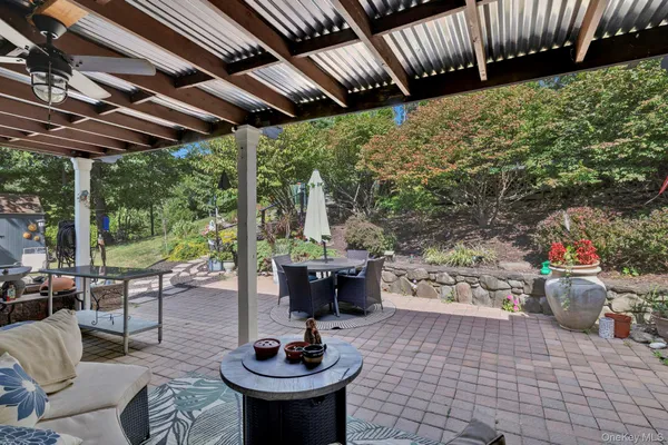 a view of a swimming pool with a patio and plants