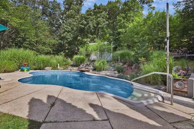 an aerial view of a house with a yard and large trees