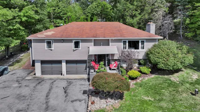 a front view of a house with a yard and a garage