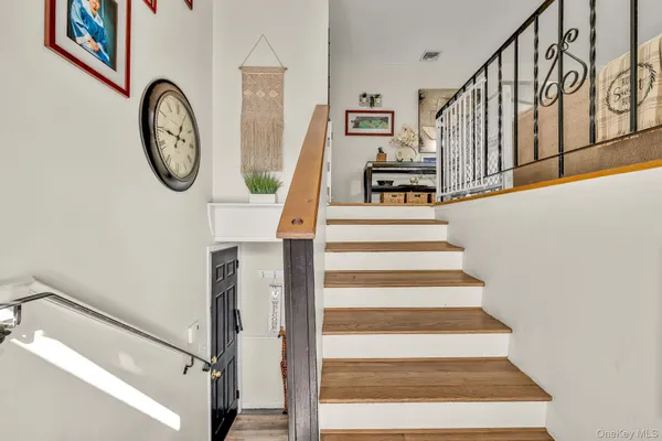 a view of staircase with white walls and a window