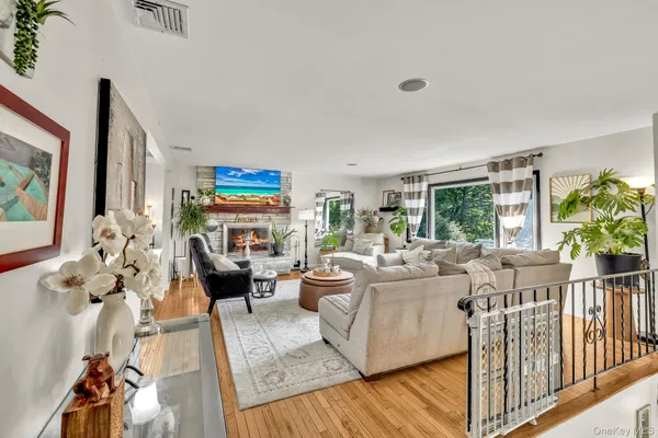 a living room with furniture fireplace and a large window