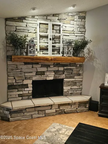 a living room with furniture kitchen view and a chandelier