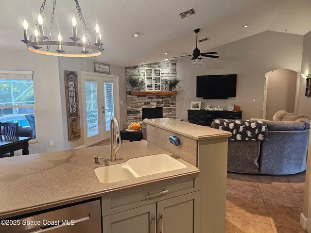 a kitchen with stainless steel appliances granite countertop a sink a stove and a refrigerator