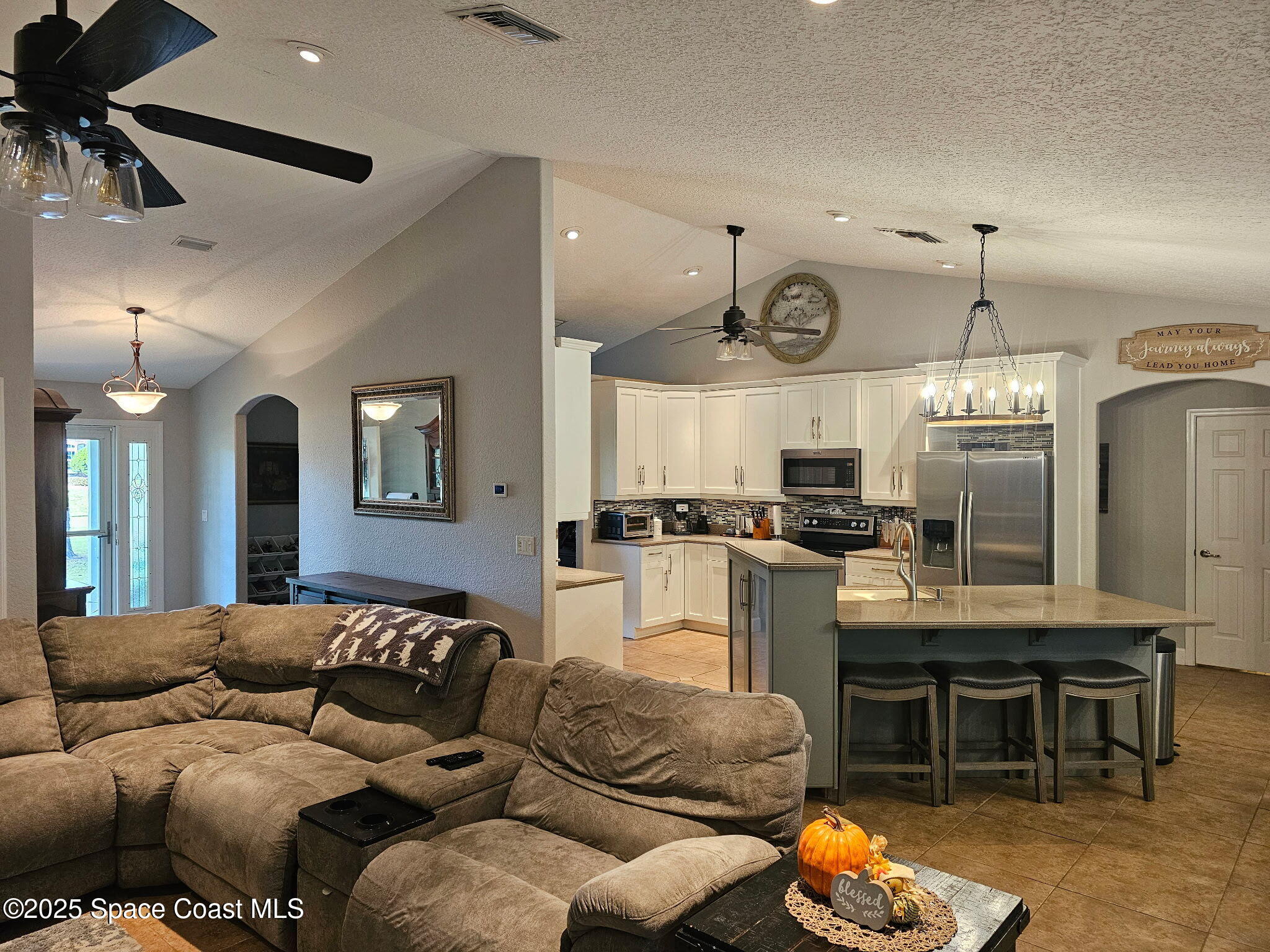 3094 Green Turtle Circle Mims, FL 32754 - Photo 18 of 63 a living room with furniture a chandelier and kitchen view