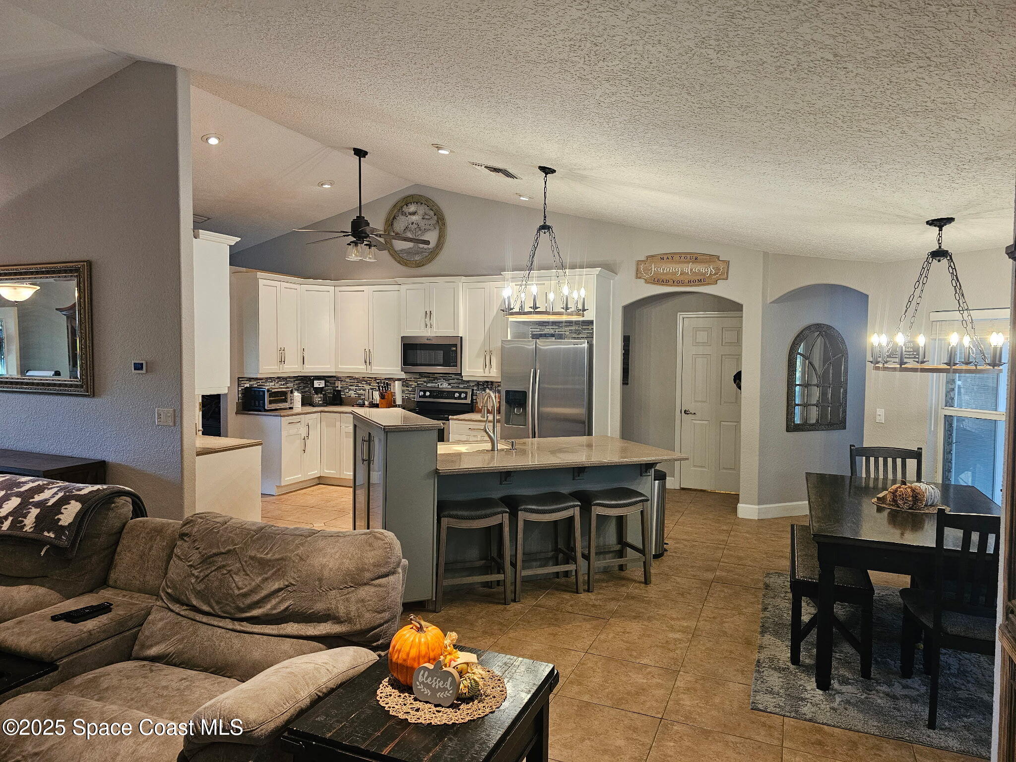 3094 Green Turtle Circle Mims, FL 32754 - Photo 19 of 63 a living room with furniture kitchen view and a chandelier