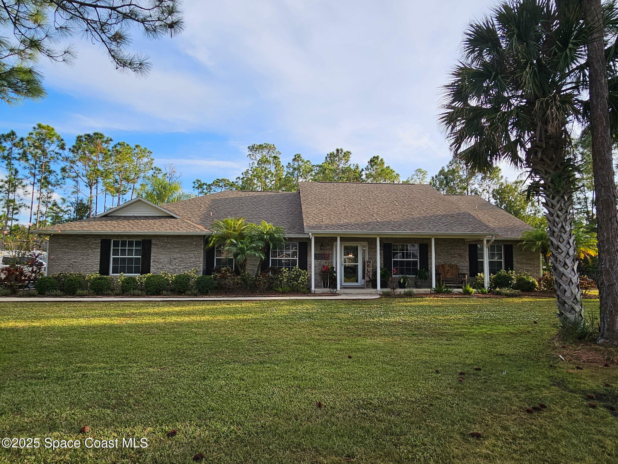 3094 Green Turtle Circle Mims, FL 32754 - Photo 2 of 63 a front view of a house with a garden