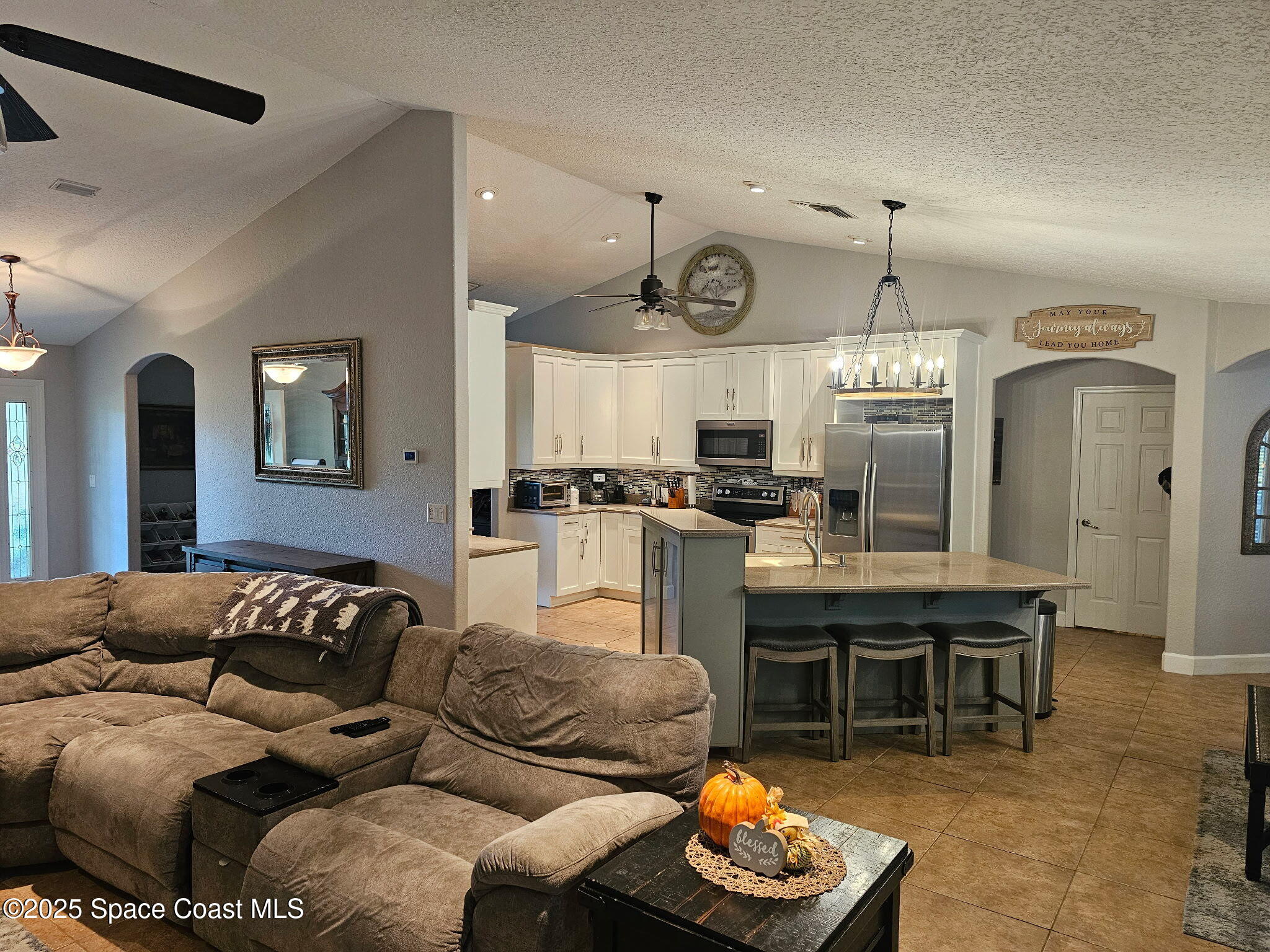 3094 Green Turtle Circle Mims, FL 32754 - Photo 21 of 63 a living room with furniture kitchen view and a chandelier