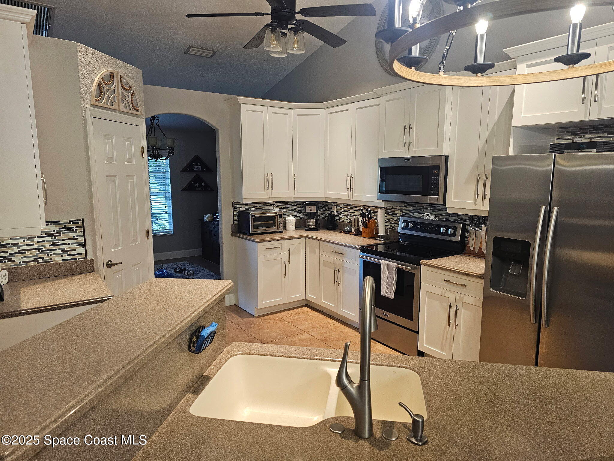 3094 Green Turtle Circle Mims, FL 32754 - Photo 22 of 63 a kitchen with stainless steel appliances granite countertop a sink a stove and a refrigerator