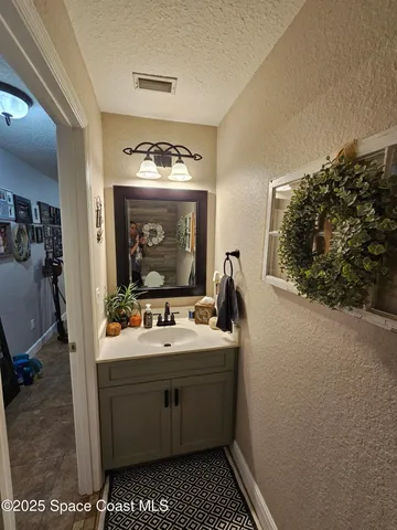 a bathroom with a sink vanity and mirror