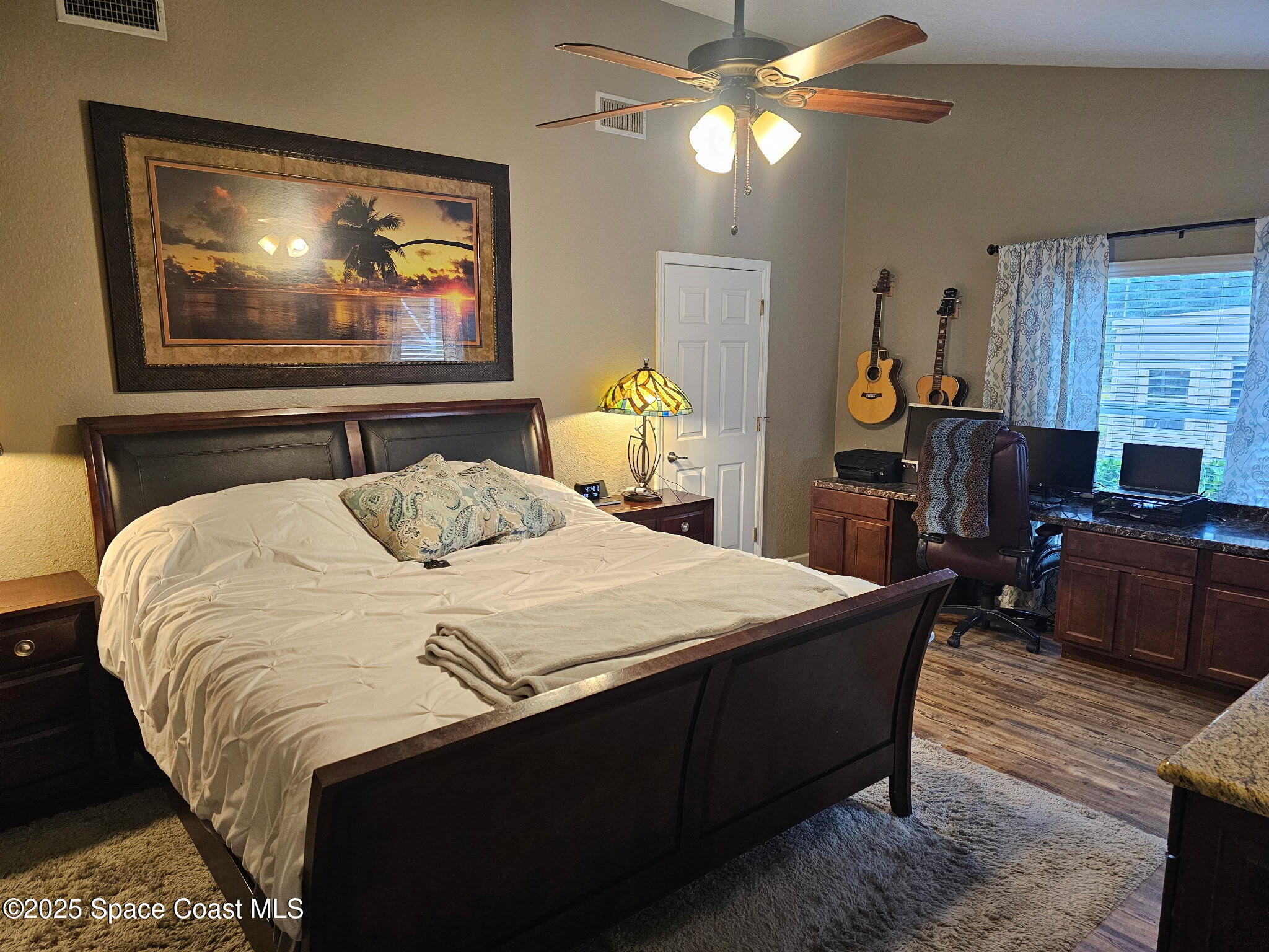 3094 Green Turtle Circle Mims, FL 32754 - Photo 27 of 63 a bedroom with a bed and a chandelier