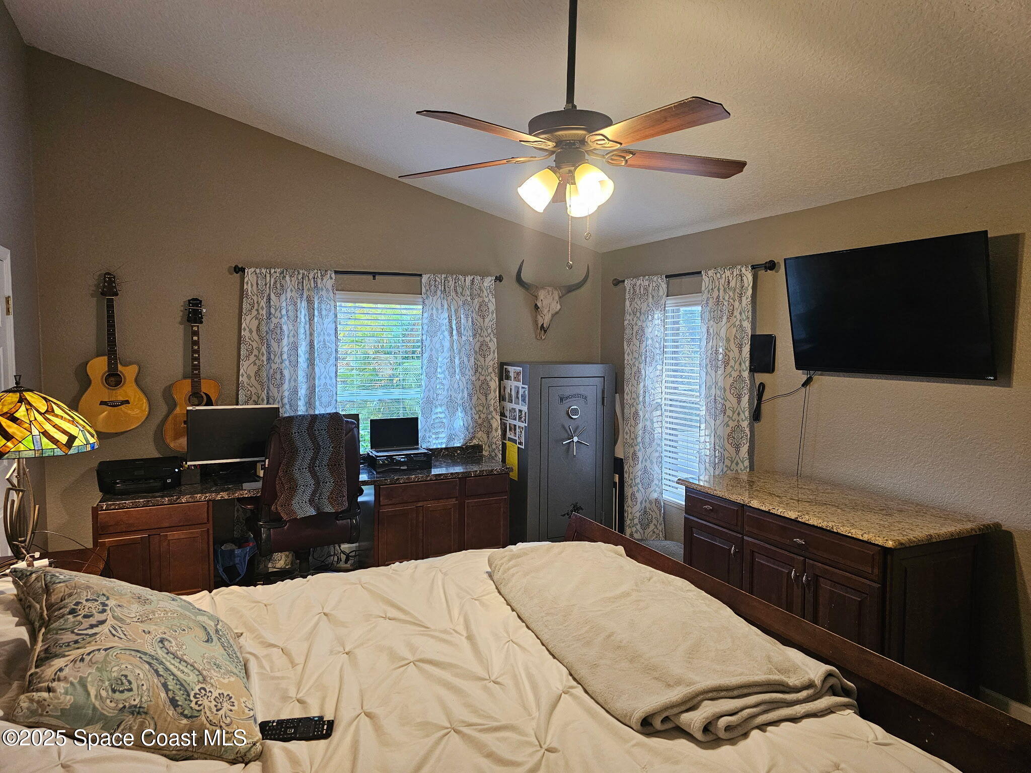 3094 Green Turtle Circle Mims, FL 32754 - Photo 29 of 63 a bedroom with a bed and a flat tv screen on dresser
