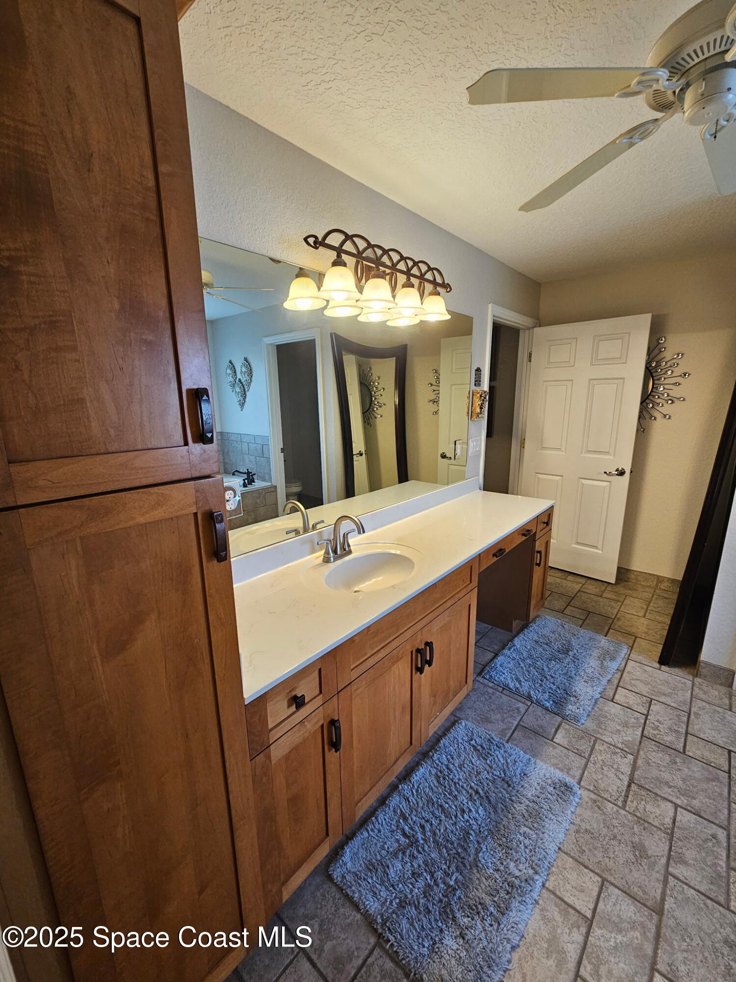 3094 Green Turtle Circle Mims, FL 32754 - Photo 30 of 63 a bathroom with a sink vanity and mirror