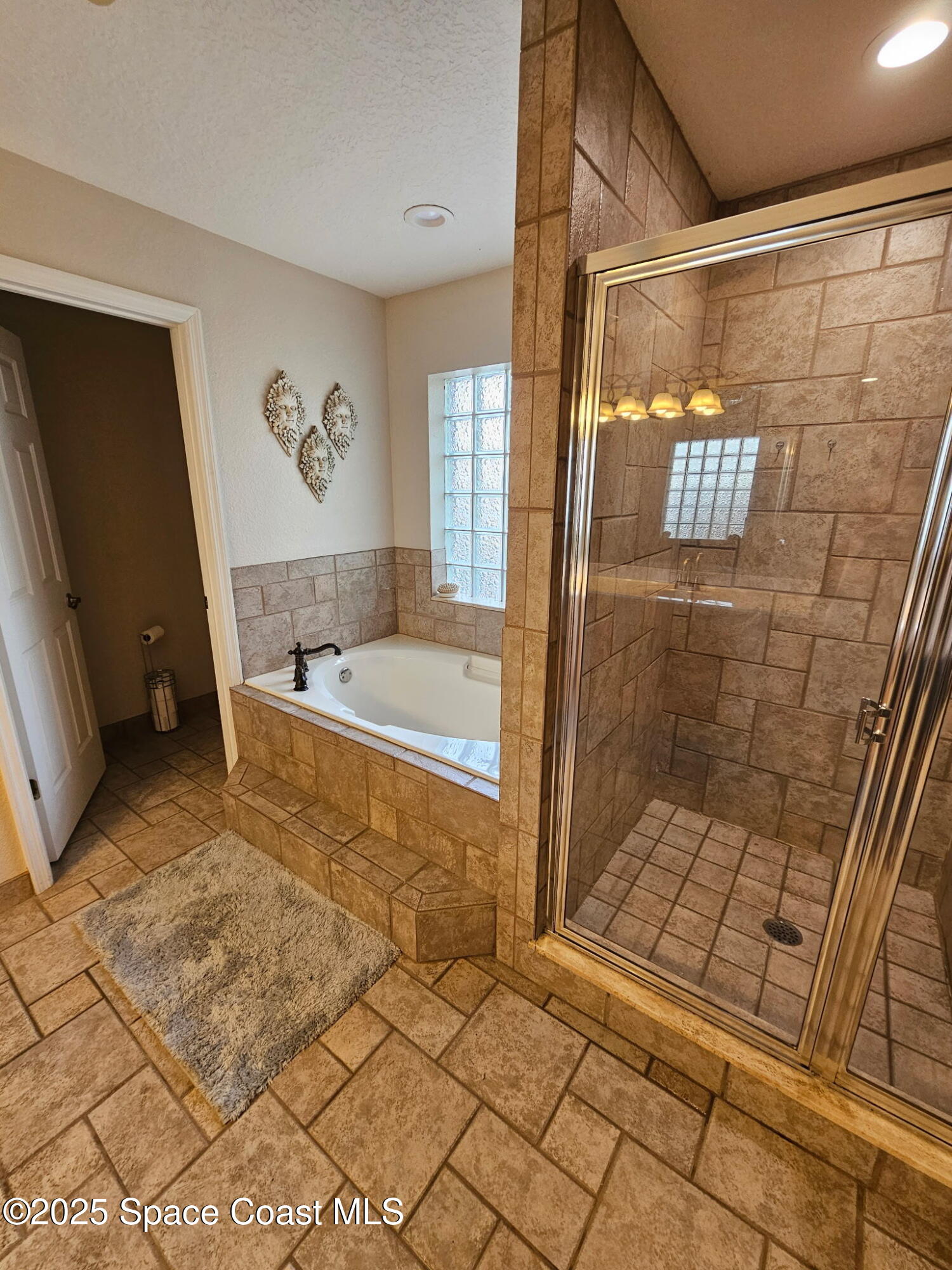 3094 Green Turtle Circle Mims, FL 32754 - Photo 32 of 63 a bathroom with a bathtub and a shower