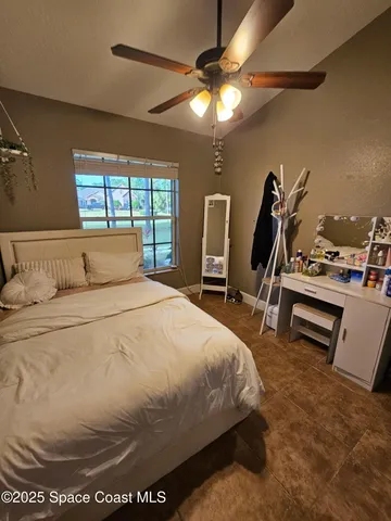 a bedroom with a bed and lamp