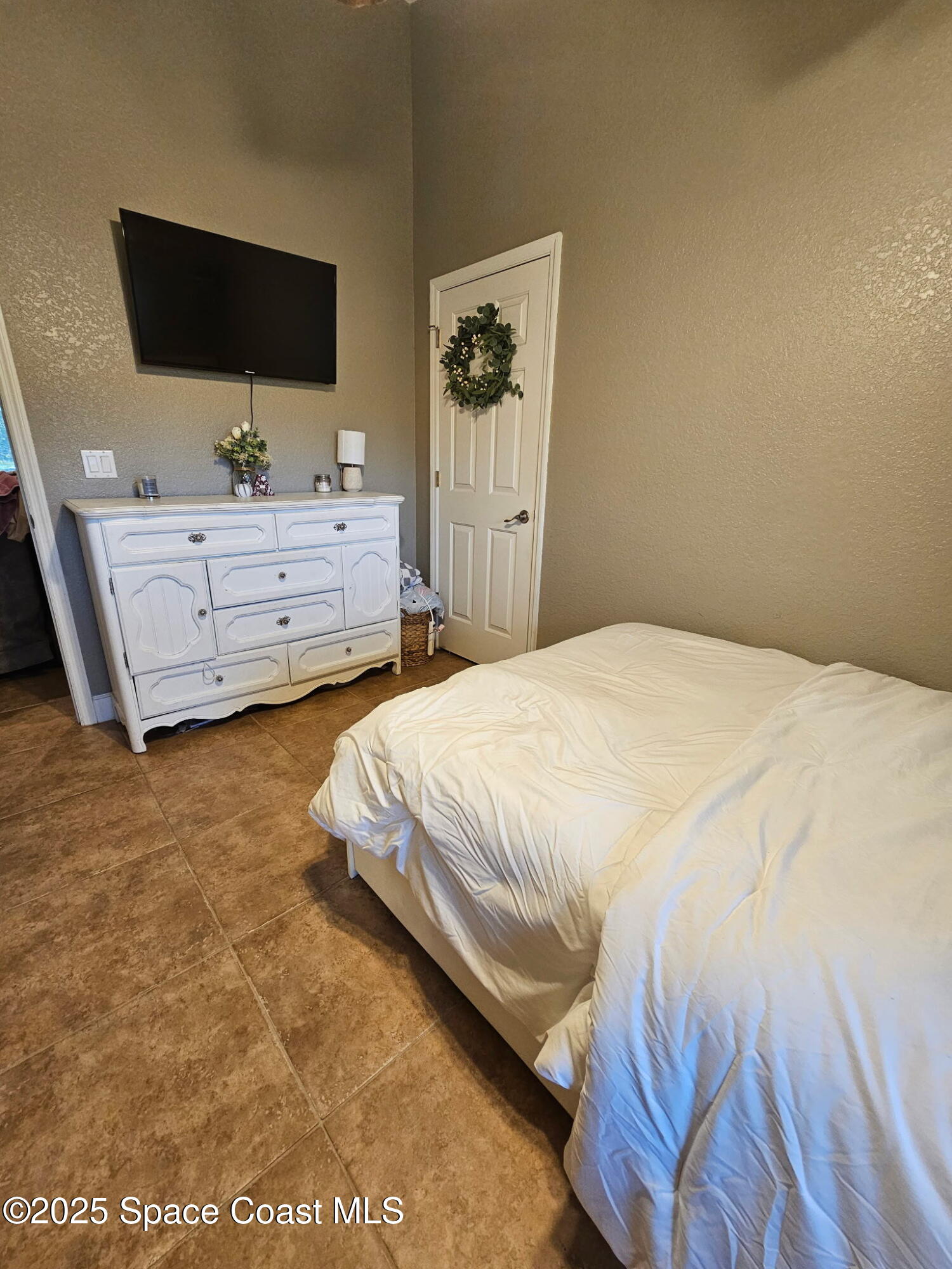 3094 Green Turtle Circle Mims, FL 32754 - Photo 36 of 63 a spacious bedroom with a bed and a flat screen tv