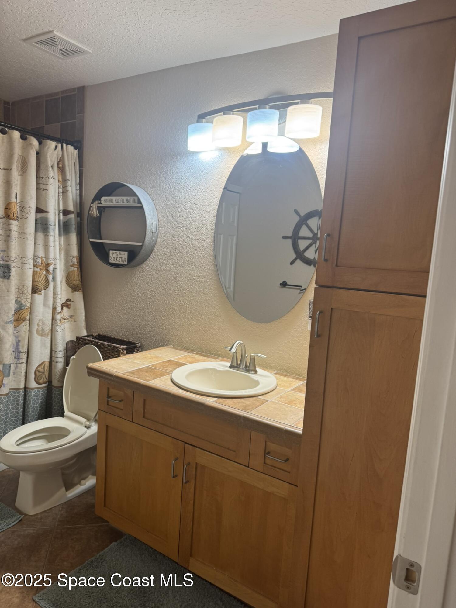 3094 Green Turtle Circle Mims, FL 32754 - Photo 41 of 63 a bathroom with a sink and a mirror