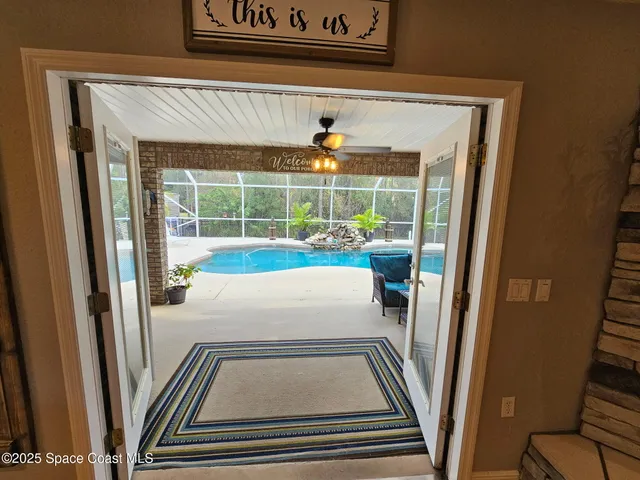 a view of a backyard with plants and large tree