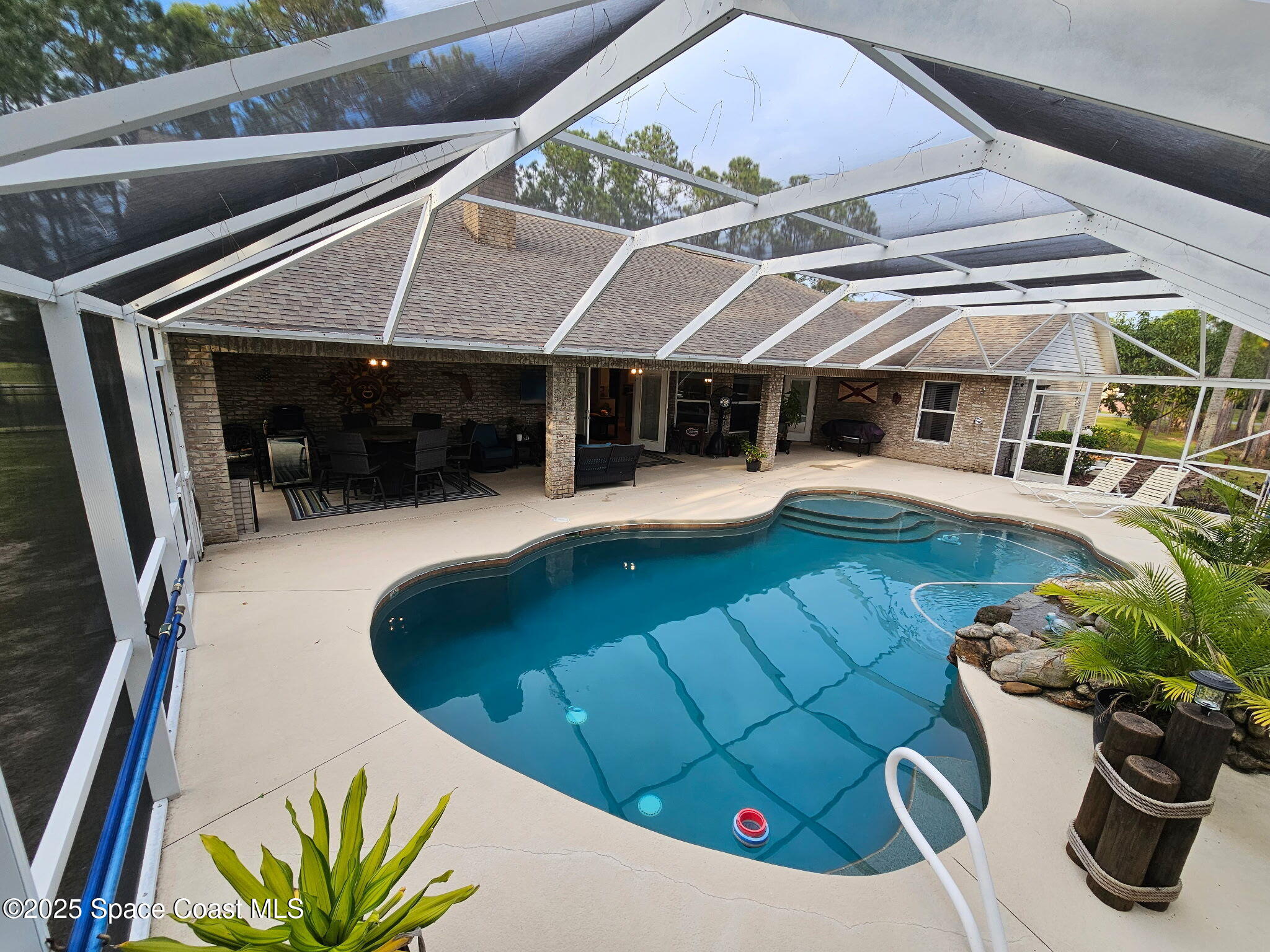 3094 Green Turtle Circle Mims, FL 32754 - Photo 52 of 63 a view of a patio with table and chairs potted plants and large tree